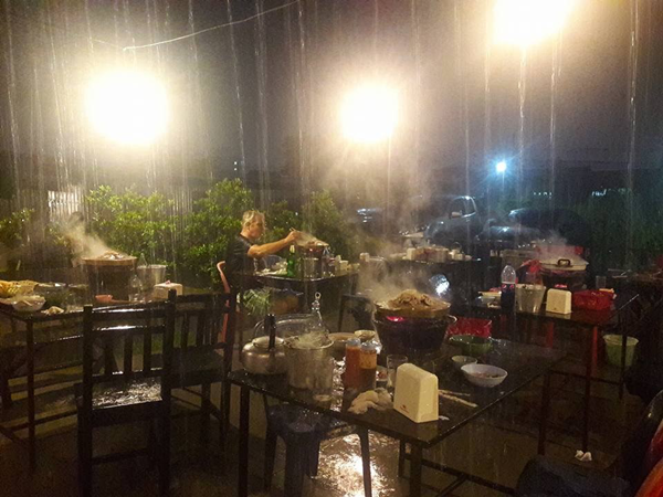 ฝรั่งนั่งชิลกินหมูกระทะท่ามกลางสายฝนโปรยปราย
