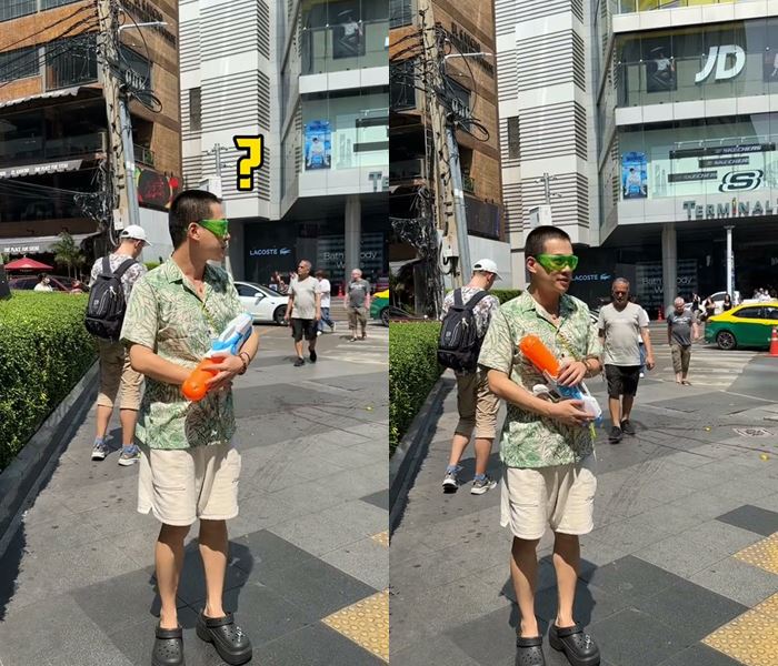 หนุ่มจีนยืนถือปืนฉีดน้ำกลางอโศก แต่ไม่มีคนเล่นน้ำ 