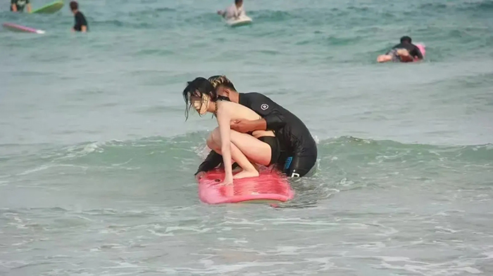 สาวเล่นเซิร์ฟริมหาด ถูกคลื่นซัดบิกินี่หลุด 